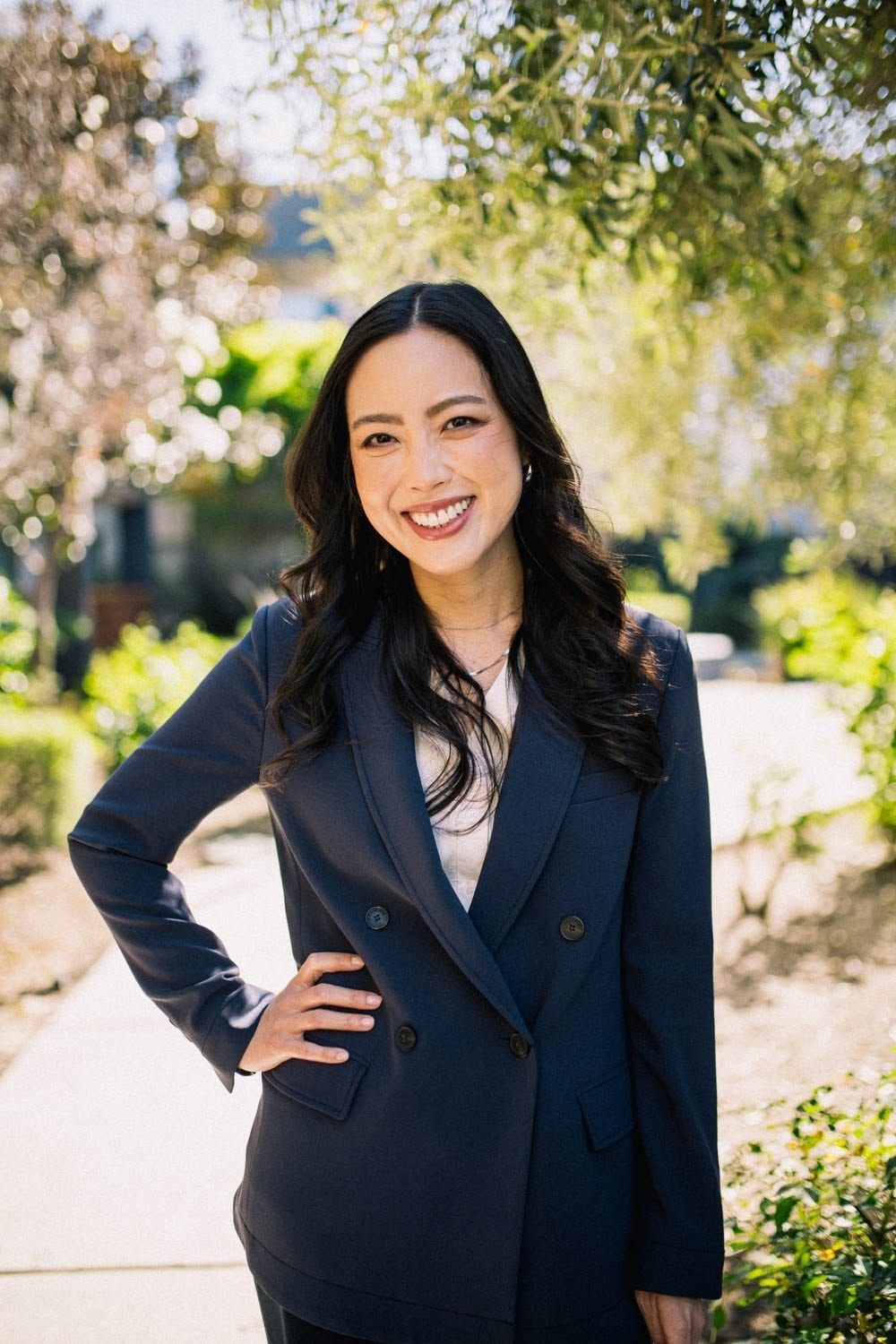 Lorraine K. Lee smiling outdoors in a navy blazer